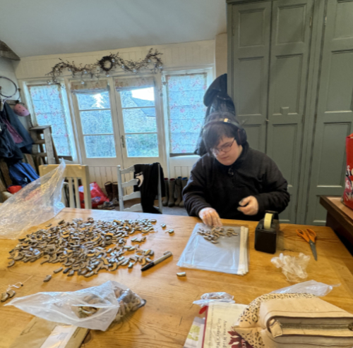 Hearing Aid Recycling favourite Coco working hard checking all of the donated hearing aids prior to packing and despatching them to Malawi