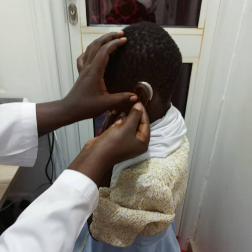 Fitting a hearing aid recycling hearing aid in Uganda