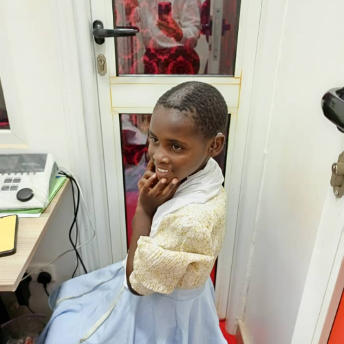 Shakira listening to her donated hearing aids